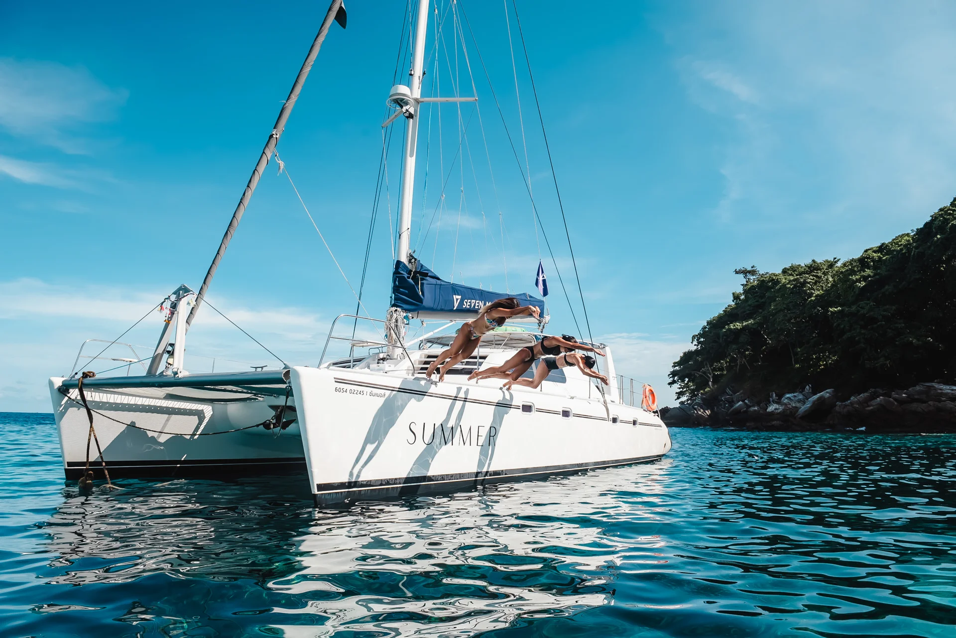 Guests diving into turquoise water from SUMMER catamaran