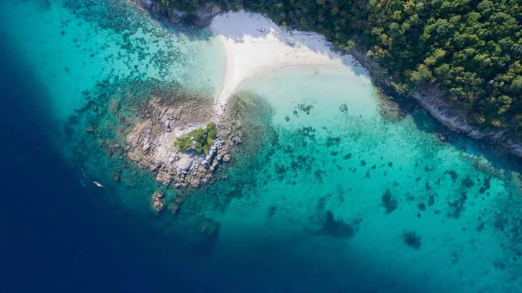 Clear blue water and the green coastline of Racha Yai near Phuket